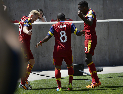 Scott Sommerdorf   |  The Salt Lake Tribune
RSL midfielder Luke Mulholland, left, celebrates his goal with Joao Plata and Olmes Garcia after Mulholland's shot gave RSL a 2-0 lead early in the second half. RSL defeated the Seattle Sounders 2-1 at Rio Tinto Stadium, Saturday, August 15, 2014. The goal was listed as an "own goal" on Seattle's Osvaldo Alonso.