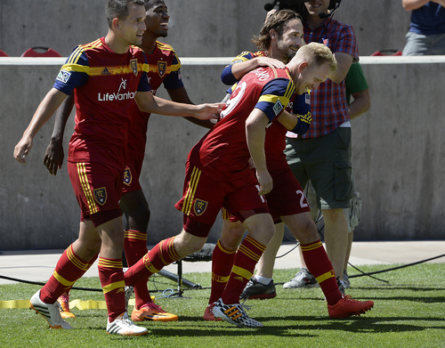 Scott Sommerdorf   |  The Salt Lake Tribune
RSL midfielderLuke Mulholland, second from right, is mobbed by team mates after Mulholland's shot gave RSL a 2-0 lead early in the second half. RSL defeated the Seattle Sounders 2-1 at Rio Tinto Stadium, Saturday, August 15, 2014. The goal was listed as an "own goal" on Seattle's Osvaldo Alonso.