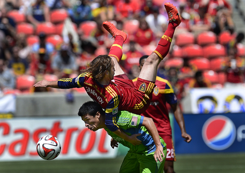 Scott Sommerdorf   |  The Salt Lake Tribune
Ned Grabavoy takes a ride on the back of Seattle's Gonazlo Pineda after both men went up to attempt a header in the second half. RSL defeated the Seattle Sounders 2-1 at Rio Tinto Stadium, Saturday, August 15, 2014.