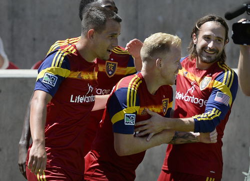 Scott Sommerdorf   |  The Salt Lake Tribune
RSL midfielderLuke Mulholland, second from right, is mobbed by team mates after Mulholland's shot gave RSL a 2-0 lead early in the second half. RSL defeated the Seattle Sounders 2-1 at Rio Tinto Stadium, Saturday, August 15, 2014.