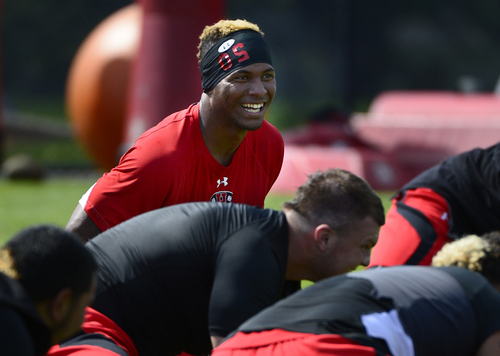 Scott Sommerdorf   |  The Salt Lake Tribune
Utah DE Pita Taumoepenu laughs during stretching drills after football practice with pads on the baseball field, Thursday, August 7, 2014.