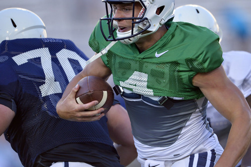 Chris Detrick  |  The Salt Lake Tribune
Brigham Young Cougars quarterback Taysom Hill (4) runs the ball during a scrimmage at LaVell Edwards Stadium Friday August 15, 2014.