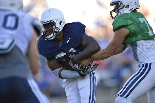 Chris Detrick  |  The Salt Lake Tribune
Brigham Young Cougars running back Jamaal Williams (21) gets a handoff from Brigham Young Cougars quarterback Christian Stewart (7) during a scrimmage at LaVell Edwards Stadium Friday August 15, 2014.