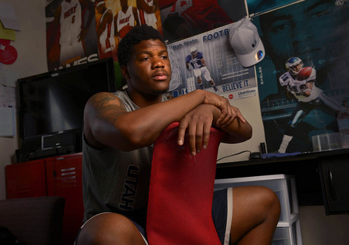 Leah Hogsten  |  The Salt Lake Tribune
Although college football is growing as an industry, the players who win the games aren't seeing much of the spoils. Former Utah State University  linebacker Tavaris McMillian sends money to his family every month and scrapes by on his scholarship stipend. McMillian, shown in his apartment room Wednesday, August 13, 2014 in Logan, is beginning to worry about his finances in the coming months when his scholarship dries up.  While athletes do get some perks, many struggle when it comes to paying bills and feeding themselves on their scholarship checks.