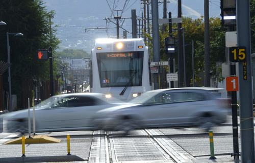 Al Hartmann  |  The Salt Lake Tribune 
The Sugar House streetcar stops for a car steaking by on 700 East Wednesday August 13, 2014.  It is only slightly faster than the nearby parallel bus, and pedestrians sometimes can outrace it. Far fewer people than projected are riding it. And it was expensive, $37 million. But officials still see it as a success and worth the price because of the economic development it has attracted.