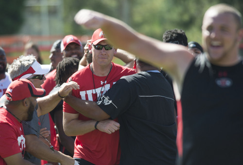 Steve Griffin  |  The Salt Lake Tribune


Coaches and players celebrate after offensive line coach Jim Harding, center, threw a football into garbage can set up downfield during the Kyle's Camp Olympics following football practice on the University of Utah baseball field in Salt Lake City, Monday, August 18, 2014. The camp Olympics consists of fun events players and coaches computer in following practice.