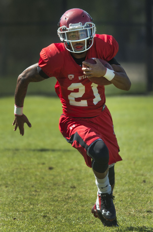 Steve Griffin  |  The Salt Lake Tribune


University of Utah running back Troy McCormick sweeps around the end during football practice on the University of Utah baseball field in Salt Lake City, Monday, August 18, 2014.