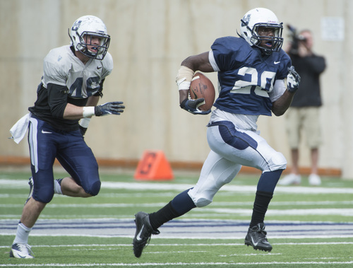 Rick Egan  |  The Salt Lake Tribune

Rahsad Hall, (20) out runs Frankie Sutera (46) for a huge gain for the blue team, in the Utah State Aggie's final spring scrimmage, Saturday, April 12, 2014