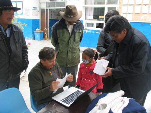 (Courtesy  | Researchers, University of Utah)
Josef Prchal, the senior author on a new study published Sunday, viisited Qinghai Province in China several times, including last September. Residents of a Tibetan village show him some papers. The researchers found a genetic mutation that enables Tibetans to thrive in the high altitude of the Tibetan Plateau.