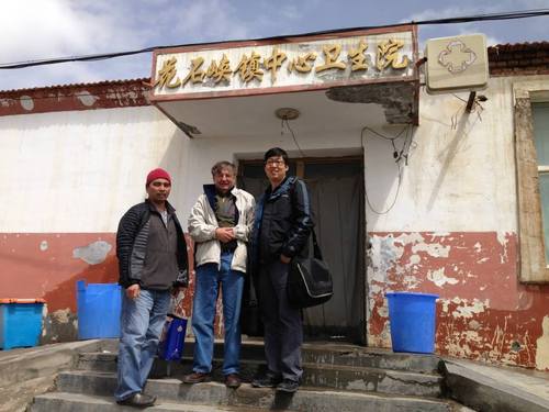 (Courtesy  |  Researchers, University of Utah)

Three University of Utah researchers are shown in front of a health center in a village of Qinghai Province in China last September. Felipe Lorenzo, on left, found the genetic mutation that enables Tibetans to thrive at high altitudes. Josef Prchal, center, was the senior author on a new study about the research, and Tsewang Tashi, born in India to Tibetan parents and now working at the Huntsman Cancer Institute, helped recruit Tibetans for the study.