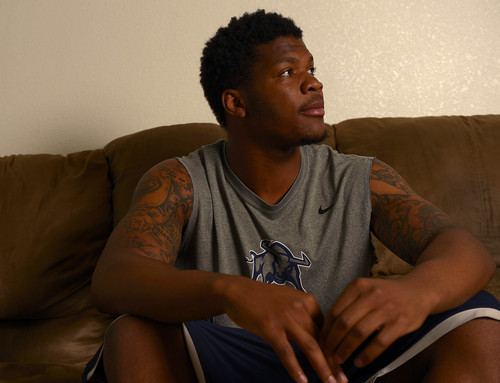 Leah Hogsten  |  The Salt Lake Tribune
Although college football is growing as an industry, the players who win the games aren't seeing much of the spoils. Former Utah State University  linebacker Tavaris McMillian sends money to his family every month and scrapes by on his scholarship stipend. McMillian, shown in his apartment room Wednesday, August 13, 2014 in Logan, is beginning to worry about his finances in the coming months when his scholarship dries up.  While athletes do get some perks, many struggle when it comes to paying bills and feeding themselves on their scholarship checks.