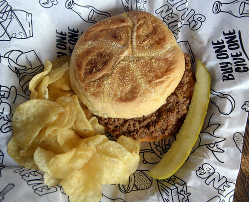 Al Hartmann  |  The Salt Lake Tribune 
Even Stevens' Sloppy Joe with beef and chrorizo, slow simmered in "slopp" sauce, pickled red onion on a Kaiser roll with chips and dill pickle.