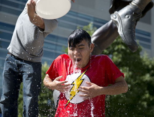 Lennie Mahler  |  The Salt Lake Tribune
Jazz fan Gerardo Galvez participates in the "ALS Ice Bucket Challenge" as Christian Madsen pours ice-cold water to raise awareness and funds to treat the disease. Karl Malone challenged all Jazz fans Wednesday night on social media.