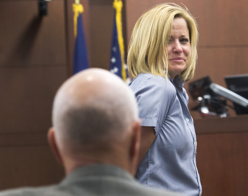 Rick Egan  |  The Salt Lake Tribune
Dea Millerberg glances back at her family as she is escorted out of Second District Court in Ogden after Judge W. Brent West sentenced her to five years at the Utah State Prison, Thursday, August 21, 2014. Millerberg pleaded guilty to helping hide the body of her teen babysitter,  Alexis Rasmussen, who overdosed on drugs at her house.