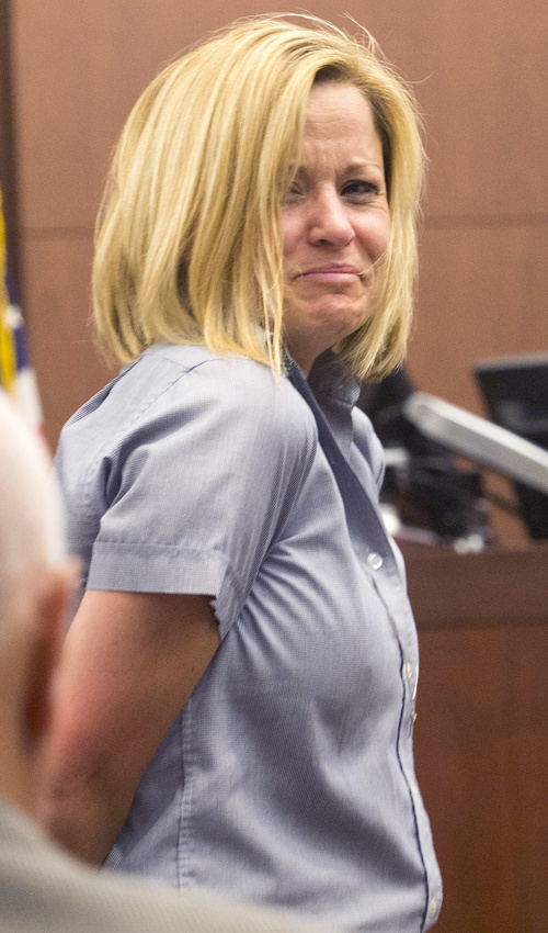 Rick Egan  |  The Salt Lake Tribune
Dea Millerberg glances back at her family as she is escorted out of Second District Court in Ogden after Judge W. Brent West sentenced her to five years at the Utah State Prison, Thursday, August 21, 2014. Millerberg pleaded guilty to helping hide the body of her teen babysitter,  Alexis Rasmussen, who overdosed on drugs at her house.
