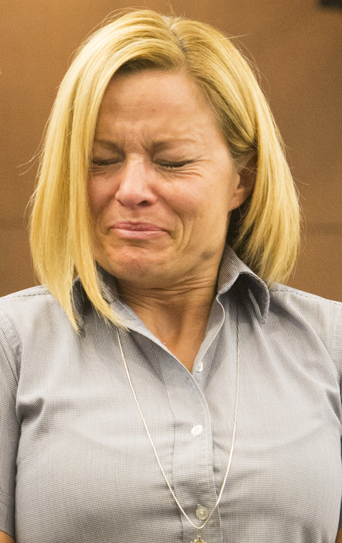 Rick Egan  |  The Salt Lake Tribune
Dea Millerberg struggles to make a statement in Second District Court during her sentencing in Ogden, Thursday, August 21, 2014. Millerberg pleaded guilty to helping hide the body of her teen babysitter who overdosed on drugs at her house.  Attorney Michael D. Bouwhuis is on the left.