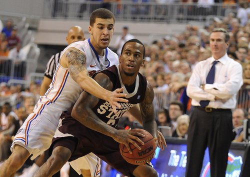 Florida's  Scottie Wilbekin (5) puts the pressure on Mississippi State's Dee Bost (3) with Mississippi State's coach Rick Stamsbury, right, watching from the sidelines during the first second of an NCAA college basketball game in Gainesville, Fla., Saturday, Jan. 28, 2012. Florida took the win from Mississippi State with a score of 69-57. (AP Photo/Phil Sandlin)
