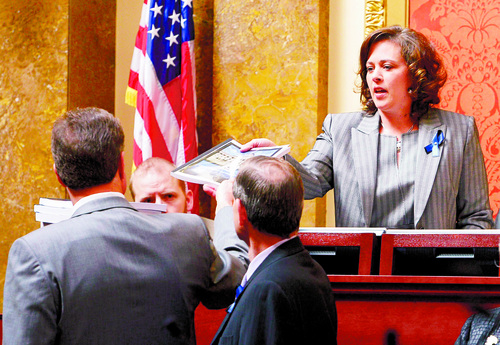 Leah Hogsten  |  The Salt Lake Tribune
Rep. Jim Dunnigan, R-Taylorsville, chairman of the investigative committee, and fellow legislators on the committee present their final report, Wednesday, March, 12, 2014, to the Utah House, and Speaker of the House Becky Lockhart (right) into former Attorney General John Swallow.  A stack of more than 200 pages with 3,700 exhibits was submitted as the result of a four-month, $4 million investigation, which contributed to Swallow's resignation.
