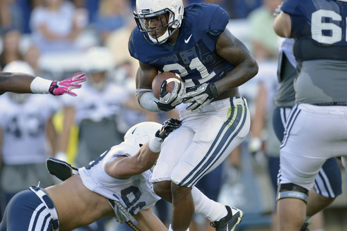 Chris Detrick  |  The Salt Lake Tribune
Brigham Young Cougars running back Jamaal Williams (21) runs the ball past Brigham Young Cougars linebacker Toloa'i Ho Ching (98) during a scrimmage at LaVell Edwards Stadium Friday August 15, 2014.
