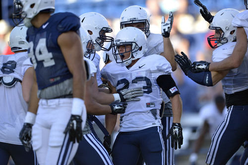 Chris Detrick  |  The Salt Lake Tribune
Brigham Young Cougars defensive back Garrett Juergens (23) celebrates an interception he had against Brigham Young Cougars wide receiver Keanu Nelson (7) during a scrimmage at LaVell Edwards Stadium Friday August 15, 2014.
