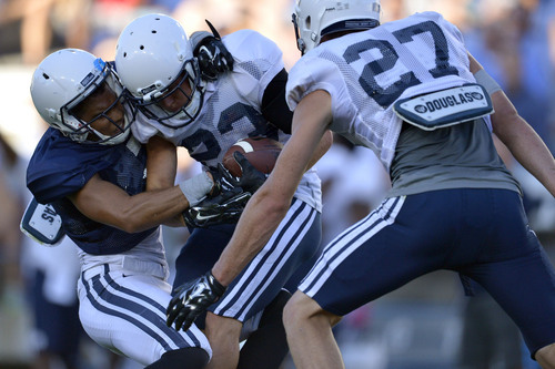 Chris Detrick  |  The Salt Lake Tribune
Brigham Young Cougars defensive back Garrett Juergens (23)  interceptions the ball from Brigham Young Cougars wide receiver Keanu Nelson (7) during a scrimmage at LaVell Edwards Stadium Friday August 15, 2014.