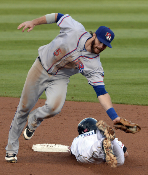 Rick Egan  |  The Salt Lake Tribune

The Bees' Shawn O'Malley slides safely into second as Round Rock Express second baseman Jason Donald attempts the tag, as The Salt Lake Bees play The Texas Round Rock Express in PCL action at Smith's Ball Park, Saturday, August 23, 2014