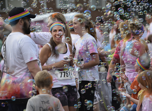 Scott Sommerdorf   |  The Salt Lake Tribune
Runners ran through a wall of bubbles on 500 South during the Color Run, Saturday, August 23, 2014.