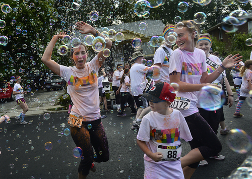Scott Sommerdorf  |  The Salt Lake Tribune
Runners ran through a wall of bubbles on 500 South during the Color Run on Saturday.