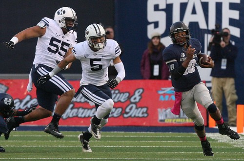 Leah Hogsten | The Salt Lake Tribune
 Utah State Aggies quarterback Chuckie Keeton (16) runs down some yardage before running out of bounds.  Brigham Young University Cougars lead 10-7 after the first quarter during their matchup against  Utah State University Aggies  Friday, October 4, 2013 in Logan.