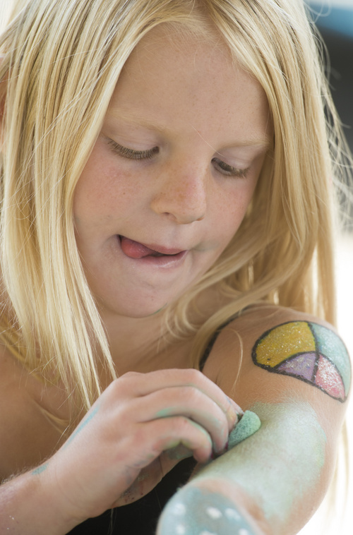 Rick Egan  |  The Salt Lake Tribune

Bailey Sabin, 8, paints her arms in the children's art area at  the 2nd Annual Ogden Valley Roots & Blues Festival at Cutler Flats in Liberty on Sunday, August 24, 2014.  The three-day festival concluded Sunday.