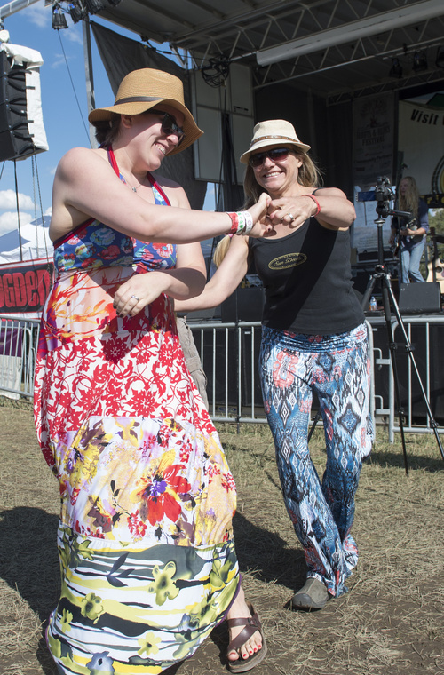 Rick Egan  |  The Salt Lake Tribune

Filke Winney, Phoenix, dances with her sister, Kara Martin, Ogden, at the 2nd Annual Ogden Valley Roots & Blues Festival at Cutler Flats in Liberty on Sunday, August 24, 2014.  The three-day festival concluded Sunday.