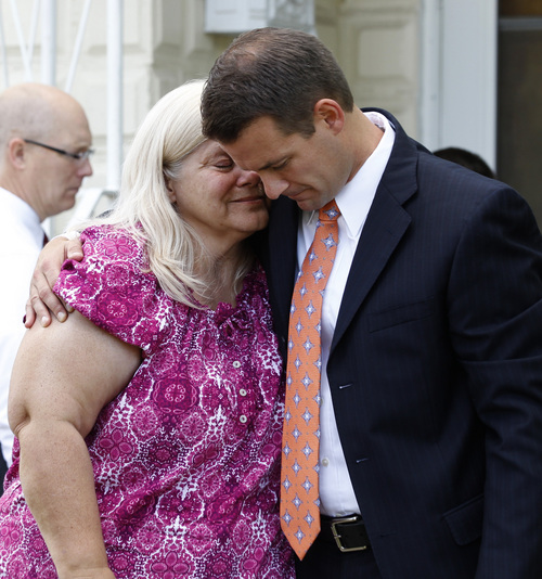 George Frey  |  Special to the Tribune
Cindy Thredgold, L, is comforted by her Mormon Stake President Blake Rapier  after a press conference about her son Connor Thredgold, in front of their home on August 23, 2014, in Springville. Connor Thredgold was serving a mission for The Church of Jesus Christ of Latter-day Saints in Taiwan and was found dead in his apartment along with another missionary.