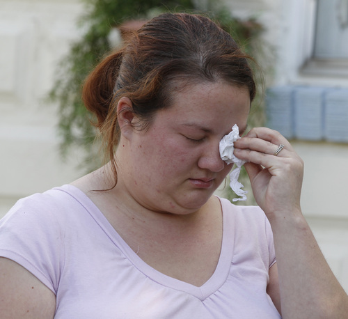 George Frey  |  Special to the Tribune
A family member wipes tears from her eyes at a press conference about Connor Thredgold, in front of their home on August 23, 2014, in Springville. Connor Thredgold was serving a mission for The Church of Jesus Christ of Latter-day Saints in Taiwan and was found dead in his apartment along with another missionary.
