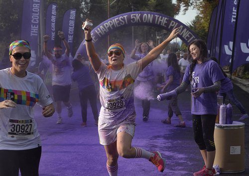 Scott Sommerdorf   |  The Salt Lake Tribune
Runners were pelted with purple just west of Liberty Park during the Color Run, Saturday, August 23, 2014.
