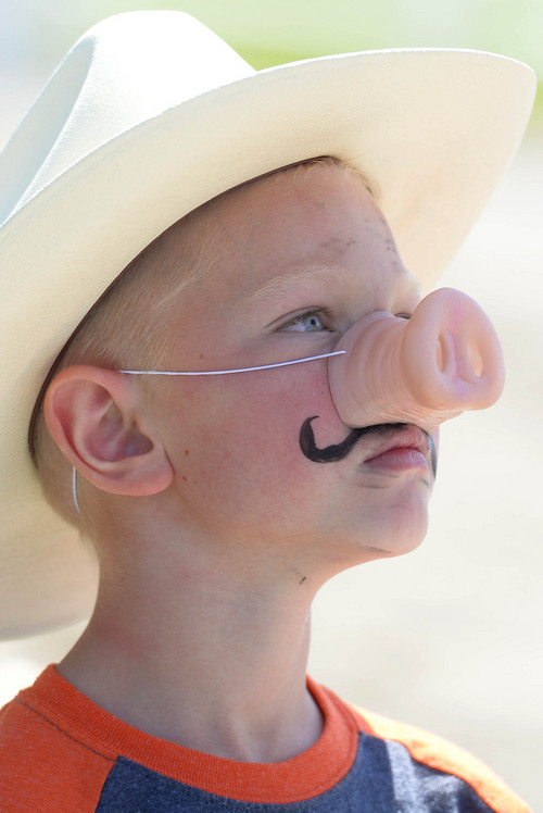 Leah Hogsten  |  The Salt Lake Tribune
Talen Mortensen, 6, of Eagle Mountain sports a mustache with his snout. Thanksgiving Point celebrated all things pig, especially bacon, with its Bacon Bash, Saturday, August 23, 2014. The event included games and pony and wagon rides.