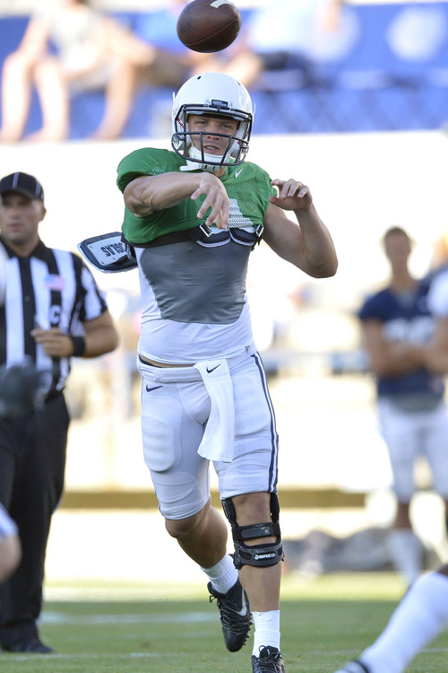 Chris Detrick  |  The Salt Lake Tribune
Brigham Young Cougars quarterback Taysom Hill (4) passes the ball during a scrimmage at LaVell Edwards Stadium Friday August 15, 2014.