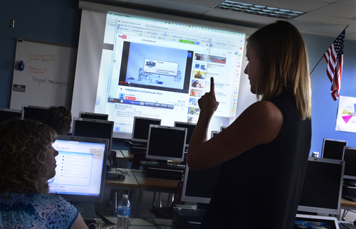 Scott Sommerdorf   |  The Salt Lake Tribune
Education tech specialist Camille Cole, right, works with Louise Atkinson, a teacher at Jordan High, on making educational videos as part of a Flip'in Utah conference at Jordan High, Wednesday, August 13, 2014.