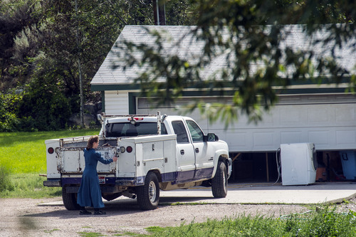 Chris Detrick  |  The Salt Lake Tribune
A woman works on Wednesday, Aug. 20, 2014, outside the home near Pocatello, Idaho, where authorities removed nine FLDS boys. Their caretaker, Nathan C. Jessop, has been charged with three misdemeanor counts of child abuse.