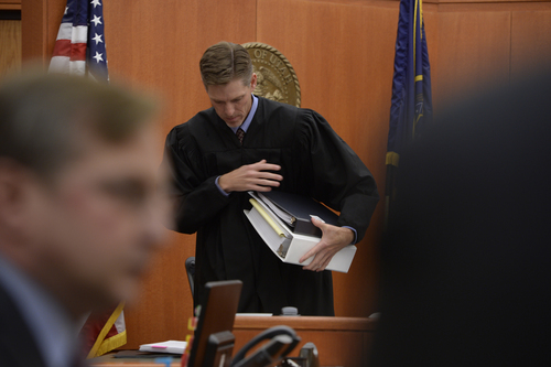 Scott Sommerdorf   |  The Salt Lake Tribune
Judge Ryan Harris gathers materials prior to a meeting with attorneys in chambers, after morning proceedings in his court on the PCMR vs Talisker matter, Wednesday, August 27, 2014.