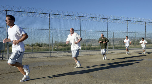Al Hartmann  |  The Salt Lake Tribune
Forty-three male inmates in the Con-Quest substance abuse program run in the first 5K race at the Utah State Prison Thursday August 28, 2014. They ran 16 laps around the fenced in jogging track made muddy from recent rain.  The 5K was a first for most inmates, who have been training in anticipation of the race and in line with the prison's Addict II Athlete program.