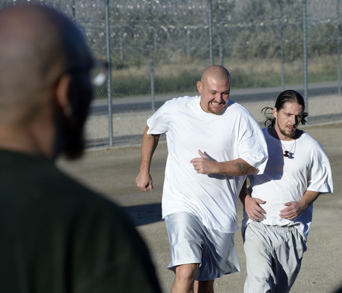 Al Hartmann  |  The Salt Lake Tribune
Forty-three male inmates in the Con-Quest substance abuse program run in the first 5K race at the Utah State Prison Thursday August 28, 2014.  They ran 16 laps around the fenced jogging track made muddy from recent rain.  The 5K was a first for most inmates, who have been training in anticipation of the race and in line with the prison's Addict II Athlete program.
