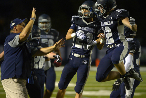 Leah Hogsten  |  The Salt Lake Tribune
Corner Canyon's  Tyler Critchfield and Hayden Lee celebrate after stopping Juan Diego. Corner Canyon High School leads Draper rival Juan Diego High School, 24-0, August 22, 2014.