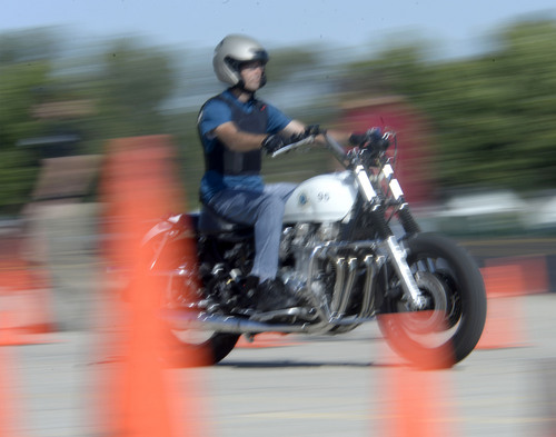 Al Hartmann  |  The Salt Lake Tribune
Officer speeds through course and gets ready to hit the brakes in a hard, controlled braking manuever at the Salt Lake City Police Department's annual motor school for officers interested in assignment to the motorcycle squad.  Students need to stop their motorcycle in 62 feet going 40 miles-per-hour. The two week long class trains at the Utah State Fairground.  The purpose of the school is to make certain candidates are able to operate a motorcycle under sceanarios encountered by motor officers on patrol. The riders must prove their skill by navigating a variety of obstacle courses and pass a hard-controlled breaking exam.