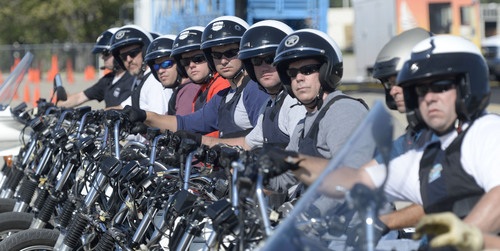Al Hartmann  |  The Salt Lake Tribune
Officers from four law enforcement agencies park their motorcycles in a tight formation and listen to instruction at the Salt Lake City Police Department's annual motor school for officers interested in assignment to the motorcycle squad.  The two week long class trains at the Utah State Fairground.  The purpose of the school is to make certain candidates are able to operate a motorcycle under sceanarios encountered by motor officers on patrol. The riders must prove their skill by navigating a variety of obstacle courses and pass a hard-controlled breaking exam.