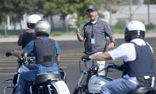 Al Hartmann  |  The Salt Lake Tribune
Salt Lake City Police Department motorcycle instructor Jody Whitaker teaches officers from four law enforcement agencies at the Salt Lake City Police Department's annual motor school for officers interested in assignment to the motorcycle squad.  The two week long class trains at the Utah State Fairground.  The purpose of the school is to make certain candidates are able to operate a motorcycle under sceanarios encountered by motor officers on patrol. The riders must prove their skill by navigating a variety of obstacle courses and pass a hard-controlled breaking exam.