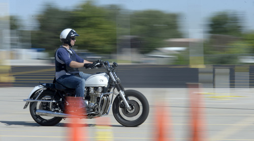 Al Hartmann  |  The Salt Lake Tribune
Officer speeds through course and gets ready to hit the brakes in a hard, controlled braking manuever at the Salt Lake City Police Department's annual motor school for officers interested in assignment to the motorcycle squad.  Students need to stop their motorcycle in 62 feet going 40 miles-per-hour. The two week long class trains at the Utah State Fairground.  The purpose of the school is to make certain candidates are able to operate a motorcycle under sceanarios encountered by motor officers on patrol. The riders must prove their skill by navigating a variety of obstacle courses and pass a hard-controlled breaking exam.
