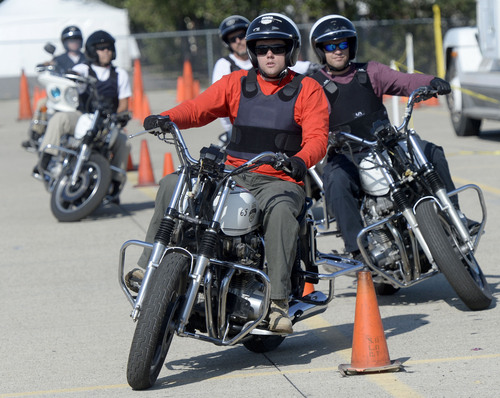 Al Hartmann  |  The Salt Lake Tribune
Officers from four other law enforcement agencies run a slalom course of orange cones to practice control at the Salt Lake City Police Department's annual motor school for officers interested in assignment to the motorcycle squad.  The two week long class trains at the Utah State Fairground.  The purpose of the school is to make certain candidates are able to operate a motorcycle under sceanarios encountered by motor officers on patrol. The riders must prove their skill by navigating a variety of obstacle courses and pass a hard-controlled breaking exam.