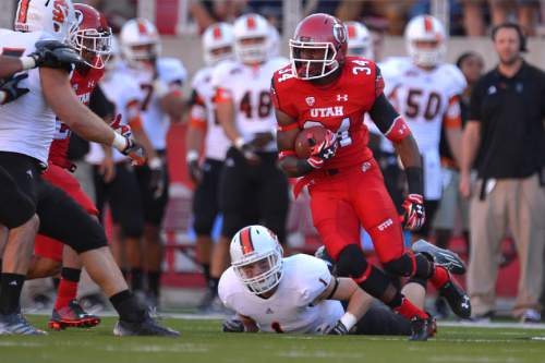 Chris Detrick  |  The Salt Lake Tribune
Utah Utes running back Bubba Poole (34) runs past Idaho State Bengals  Anthony Ricks (1) during the first half of the game at Rice-Eccles stadium Thursday August 28, 2014. Utah is winning the game 35-7.
