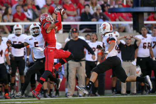 Chris Detrick  |  The Salt Lake Tribune
Utah Utes wide receiver Dres Anderson (6) makes a catch past Idaho State Bengals Brandon Golden (5) and Idaho State Bengals defensive back Cody Sorensen (29) during the first half of the game at Rice-Eccles stadium Thursday August 28, 2014. Utah is winning the game 35-7.