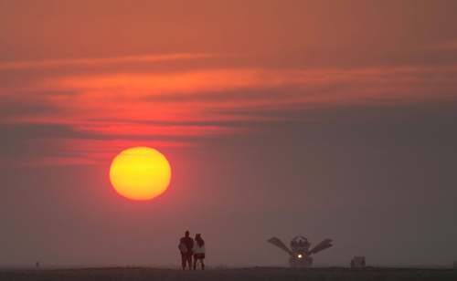 Rick Egan  |  The Salt Lake Tribune

A couple watches the sunrise at the Burning Man festival in the Black Rock Desert, north of Reno, Saturday morning, August 30, 2014.